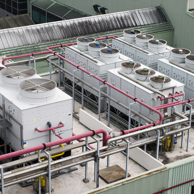Rooftop cooling towers and pipework at an industrial plant
